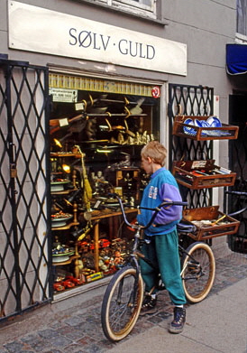 DENMARK, Copenhagen, boy browsing in antique shop window, 402 deep