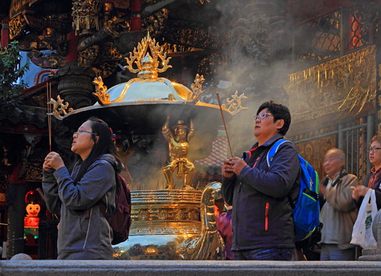 Taiwan, TAIPEI, Lungshan Temple, worshippers by incense burner censer, night view, TAW630JPL A 600