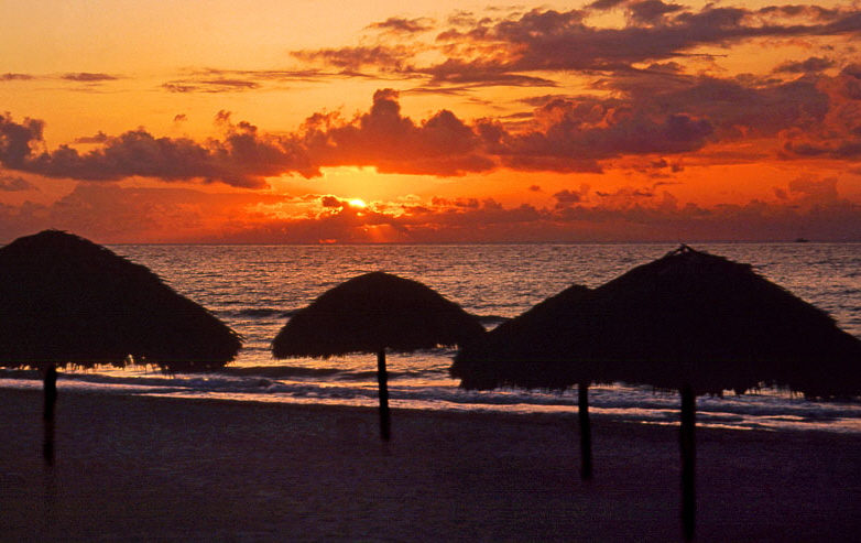 CUBA, Varadero, beach, sunset and thatched sunshades, CUB252JPL 800