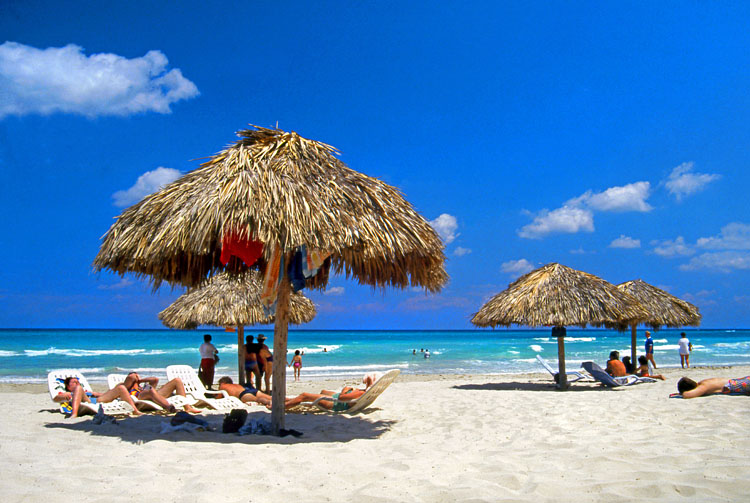 CUBA, Varadero, beach, thatched sunshades and sunbathers, CUB244JPL 750