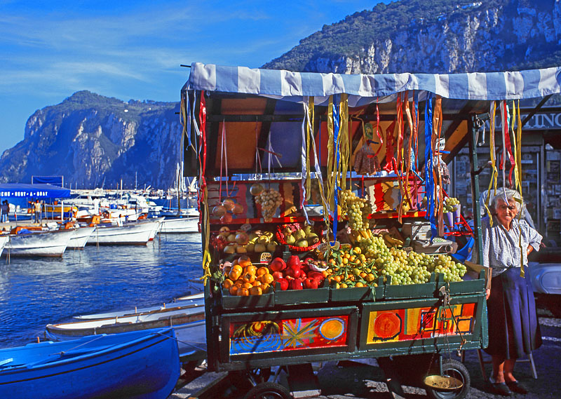 ITALY, Campania, Amalfi Coast, CAPRI, fruit stall, marina and mountain background, ITL957JPL  800