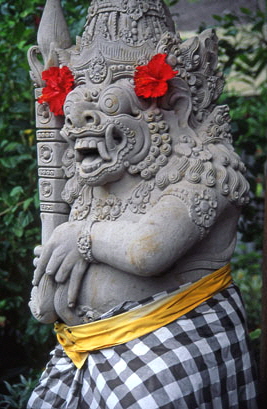 Indonesia, BALI, temple stone statue with 'kain polens' cloth (symbol of good and evil), BAL1079JPL A 280