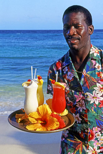 BAHAMAS, Paradise Island, waiter on beach with cocktails on tray, BAH297JPLA 330