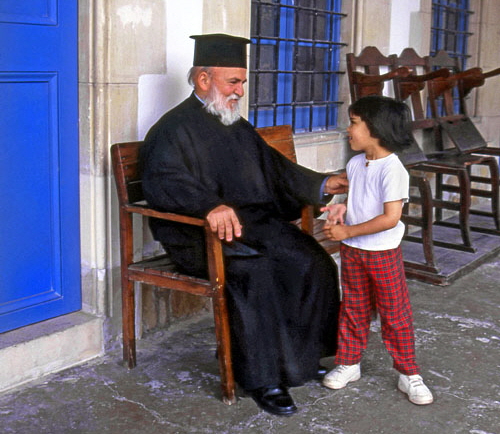 CYPRUS, Larnaca, Ayios Lazarus Church, priest talking to child, CYP112JPL A 500